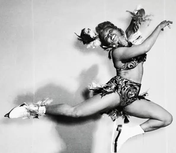 Mabel Fairbanks mid-leap in a feathered show costume during an ice revue performance