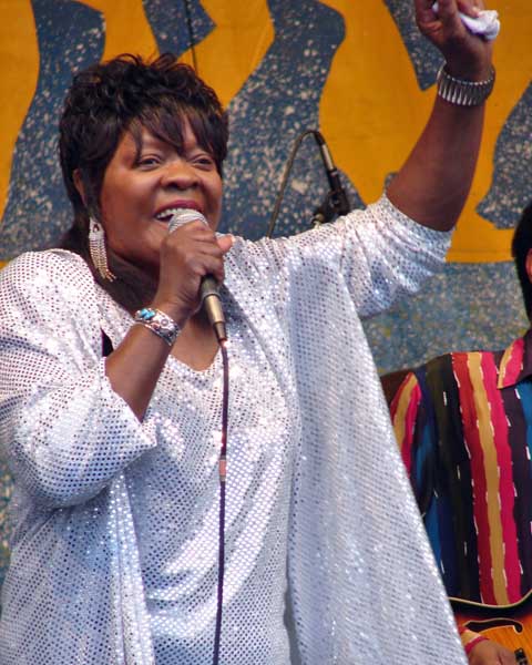 Koko Taylor performing at the New Orleans Jazz & Heritage Festival, 2006, in a sparkling outfit, mid-song.
